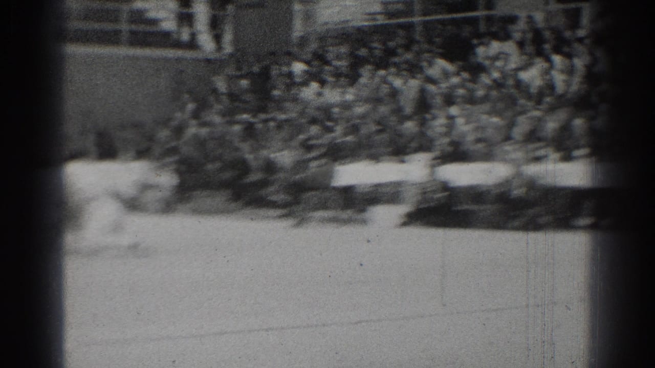 The 1966 indoor gym scene shows spectators in bleachers and officials' tables while the match action falls mostly outside the frame.