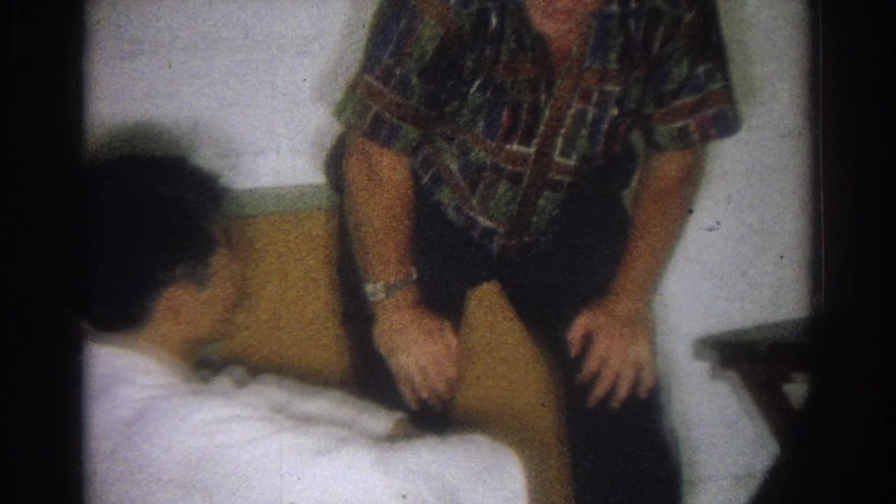 Soft 8mm frame from West Covina in 1966 showing the patterned-shirt instructor seated next to the karate student.