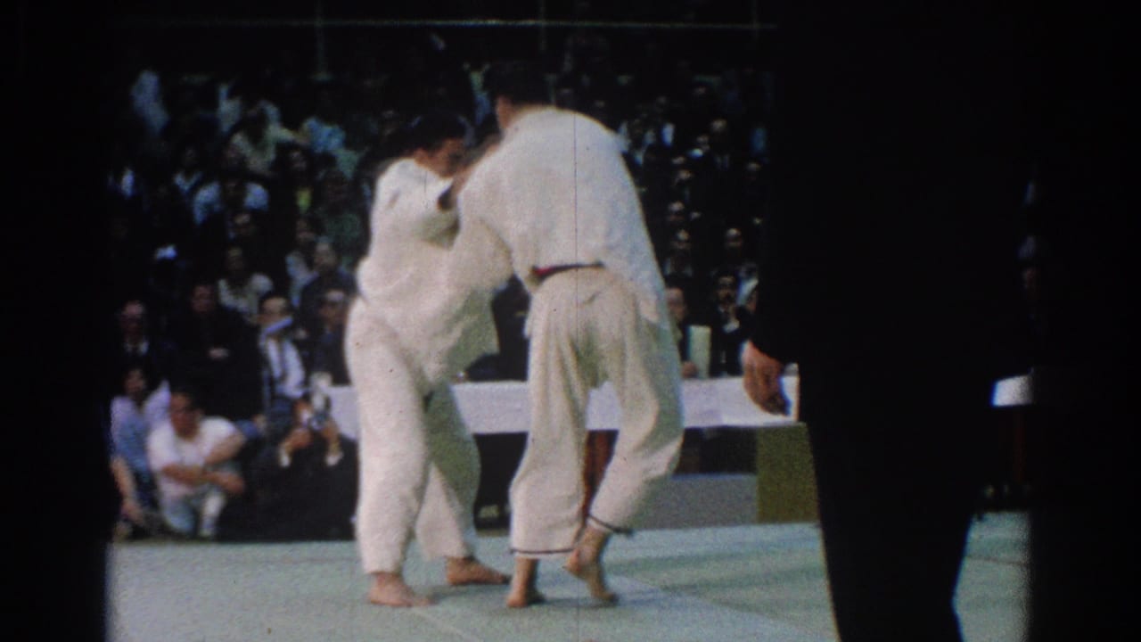 In the final visible frame, the 1966 West Covina karate match continues as an official stands near the mat edge.
