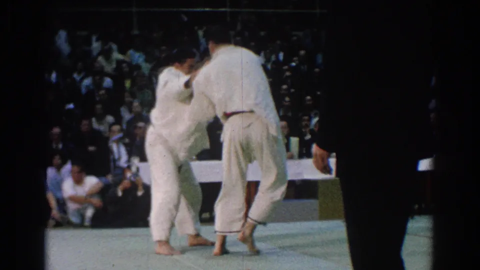 In the final visible frame, the 1966 West Covina karate match continues as an official stands near the mat edge.