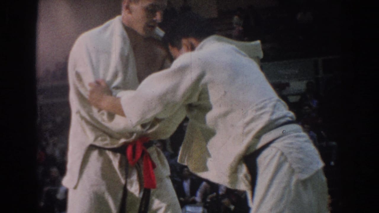 Near the end of the clip, the two adult judokas maintain close grips on the mat during the 1966 West Covina indoor competition.