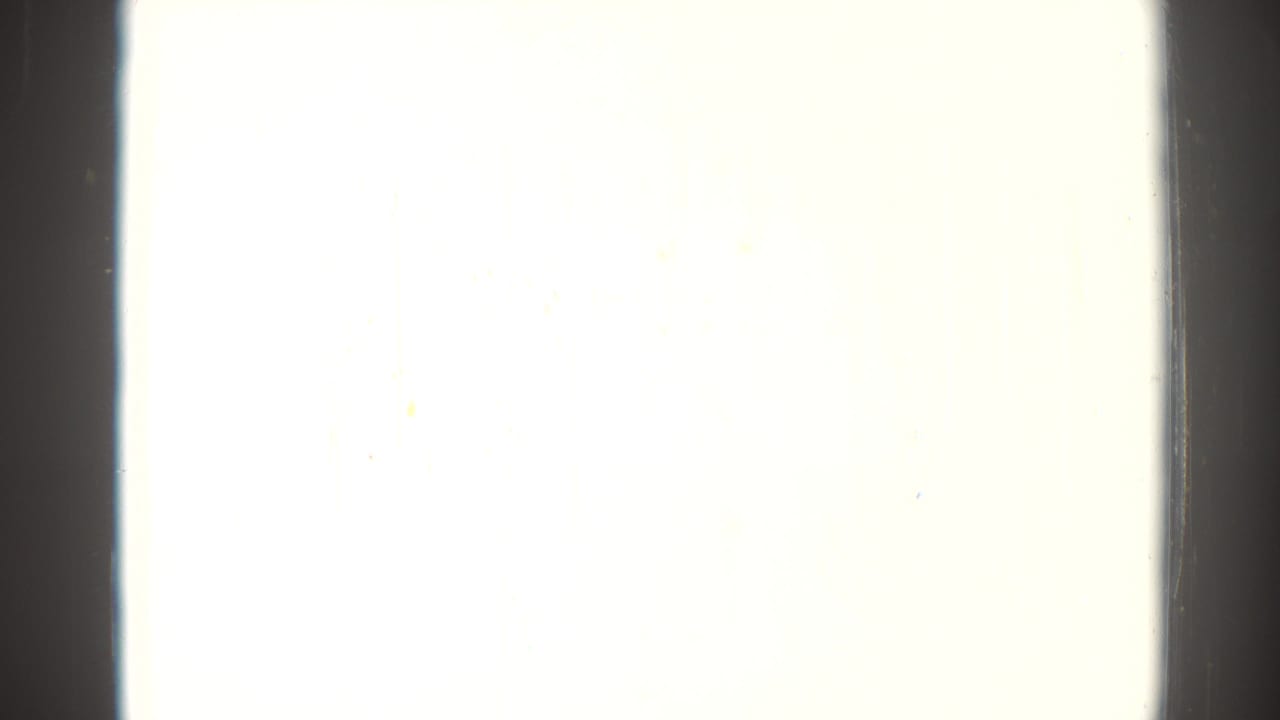 Overexposed white frame bordered by dark vertical film edges.