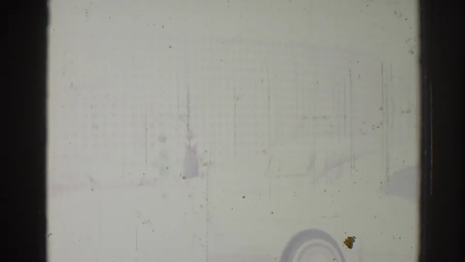 1967 Los Angeles 8mm home-movie frame with heavy wear, dark gate edges, a pale ground or wall surface, and faint rounded detail.