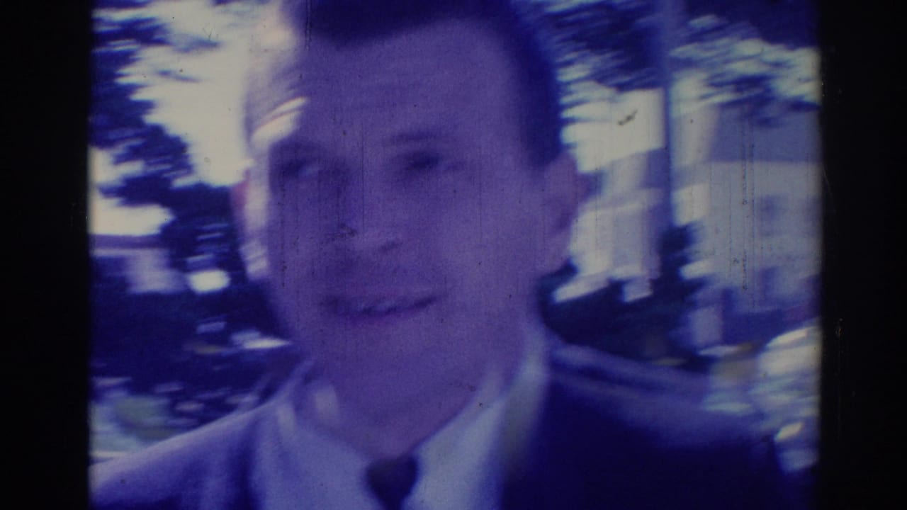 Soft, motion-blurred close-up of a suited man outdoors.