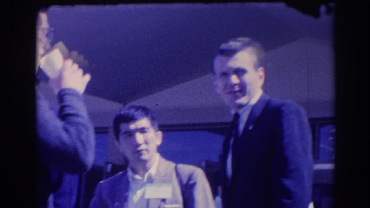 Candid 1967 Los Angeles frame of suited men with visible faces during a professional social gathering.