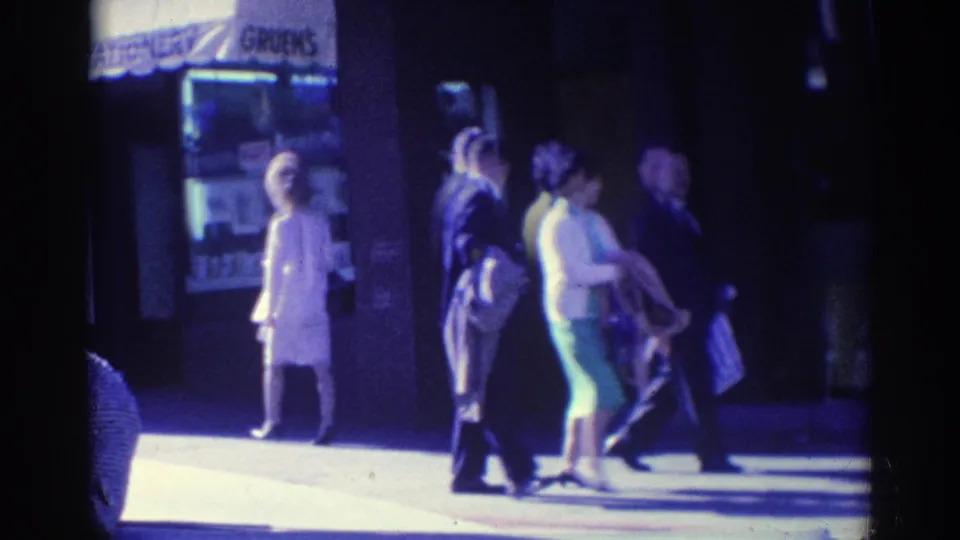 Los Angeles sidewalk scene from 1967 showing pedestrians, dresses, suits, and a visible Gruen's sign near a storefront entrance.