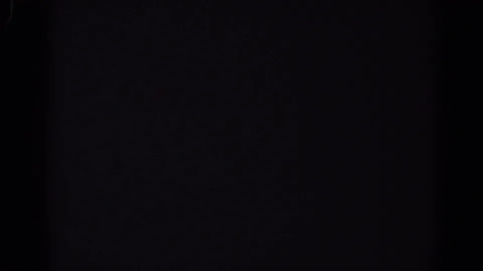 Nearly black 8mm frame from the 1967 Los Angeles clip, showing only faint film texture and possible gate shadow.