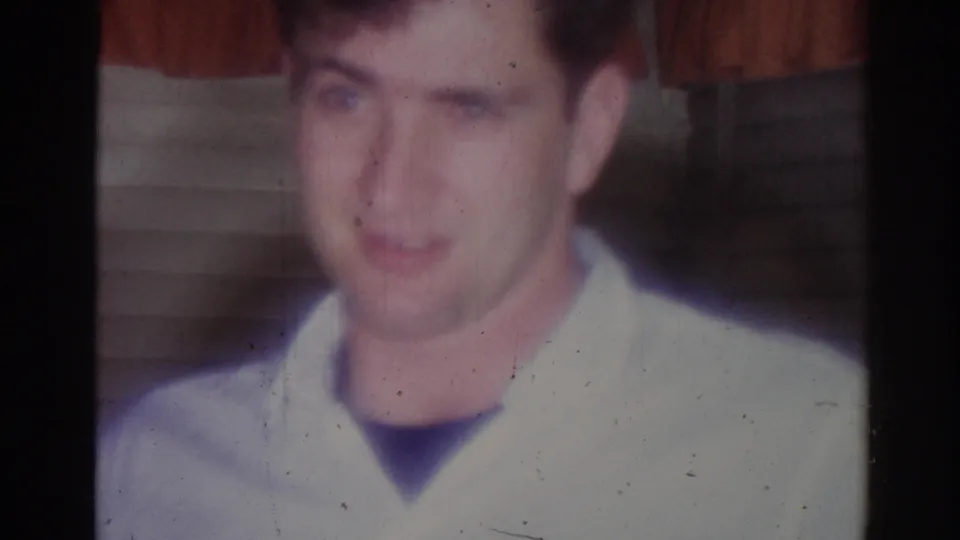 Soft, faded close-up from the 1967 home movie shows the young man indoors against drawn blinds in a Los Angeles private interior.