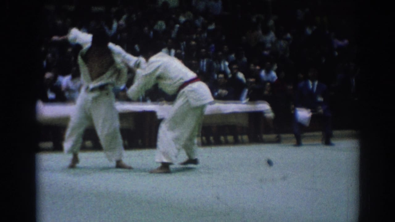 Color 8mm frame of two judo competitors in Los Angeles, one leaning back while gripping the other's gi during a possible throw attempt.