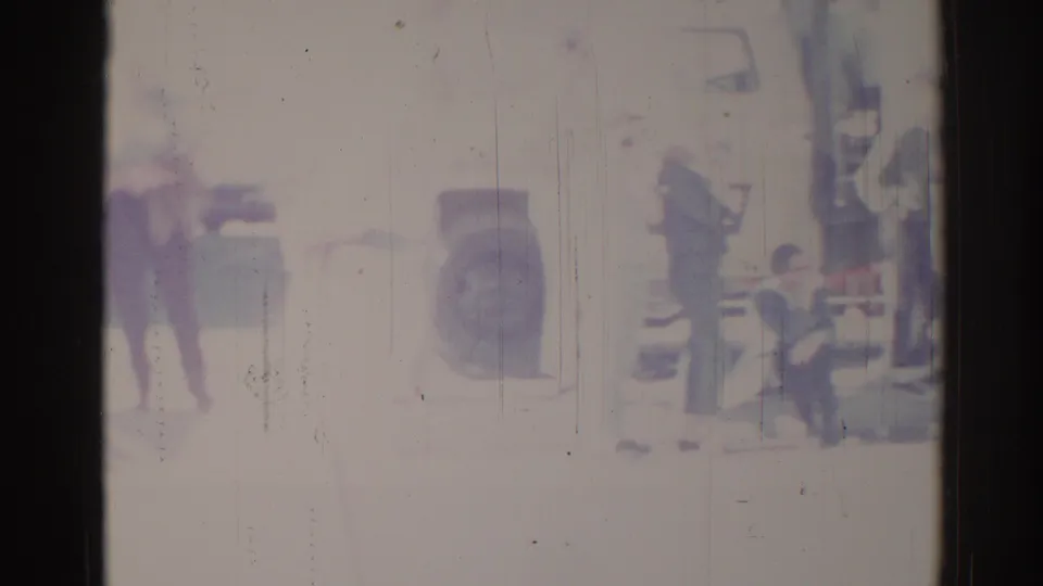 Faded 1967 Los Angeles home-movie frame appears to show a civic parade scene with distant people and possible band members in a public space.