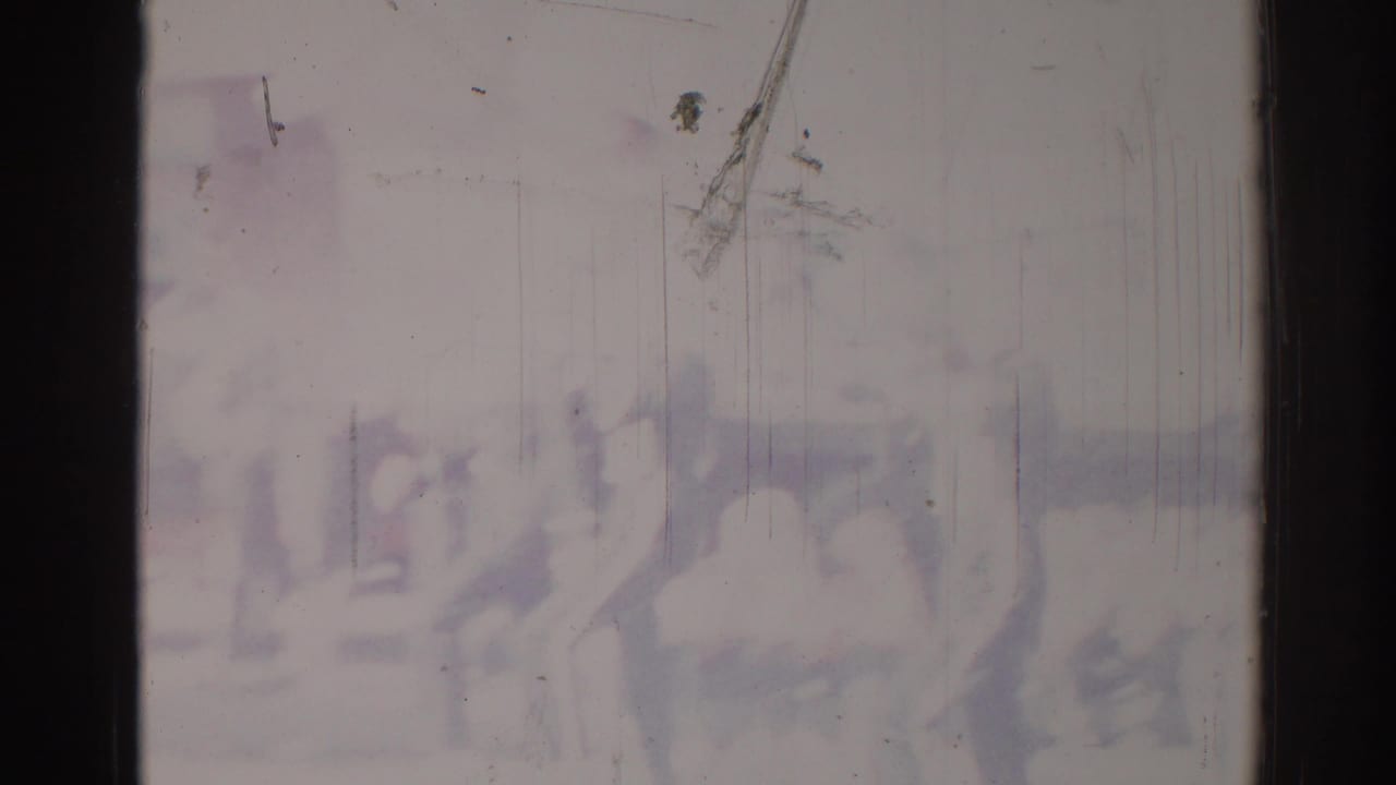 Hazy silhouettes of people in motion behind scratched 8mm film and dark frame borders.
