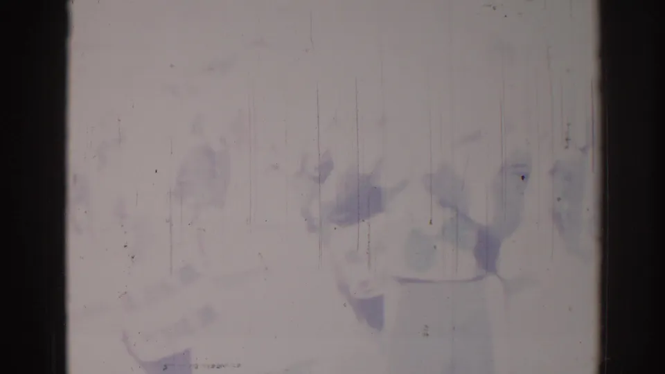 Damaged 1967 Los Angeles 8mm frame with barely visible performers and heavy vertical scratches across a faded image.