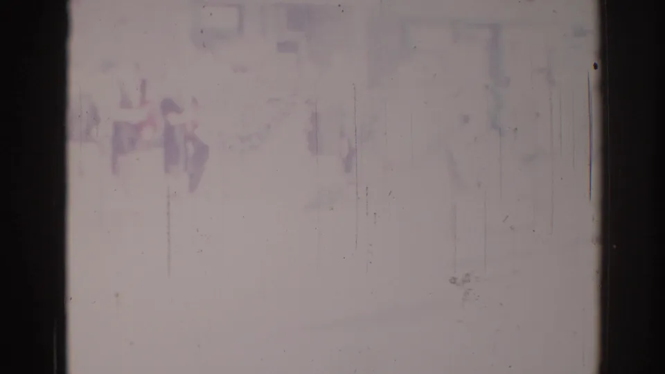 Final damaged 1967 Los Angeles parade frame with vague performer shapes, purple-blue fading, and visible film wear.