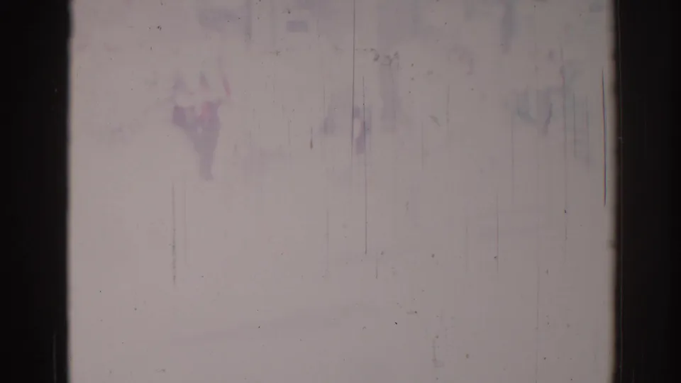 1967 Los Angeles 8mm source frame showing dark gate edges, pale exposure, fine scratches, dust specks, and faint purple-blue stains.