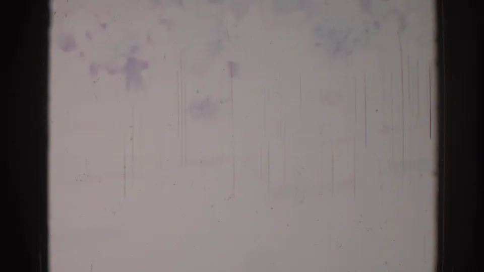 1967 Los Angeles 8mm frame detail with a dark vertical gate edge, worn pale film surface, scratches, dust, and muted color staining.