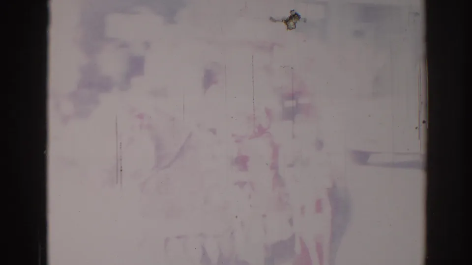 Overexposed 8mm frame from 1967 Los Angeles with faint outlines of a horse, rider, and town street setting.