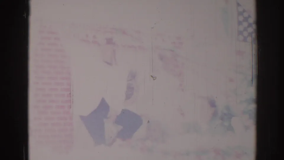 1967 Los Angeles home-movie frame with washed-out parade decorations, brick-patterned detail, and indistinct passing figures.