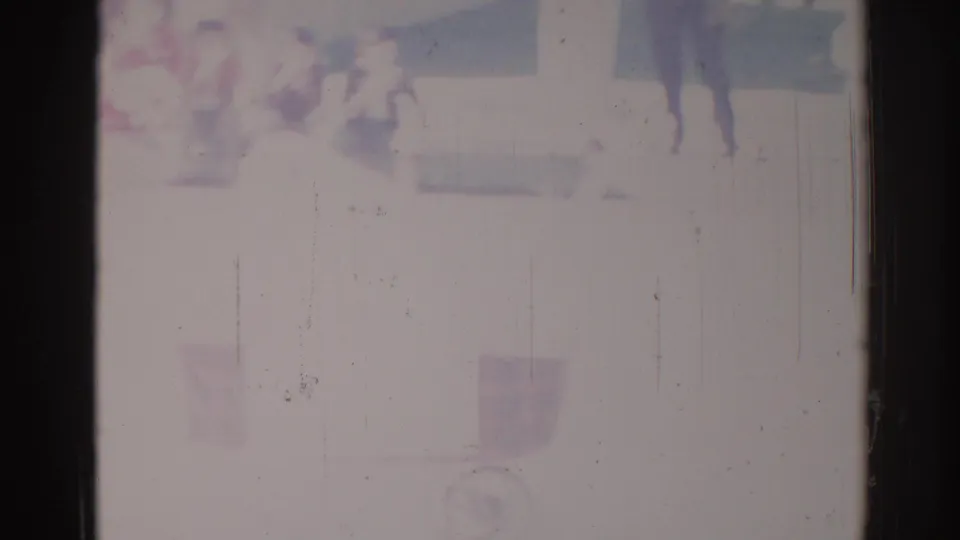 Washed 1967 Los Angeles frame where distant people and a barely visible carriage-like form appear through fading.