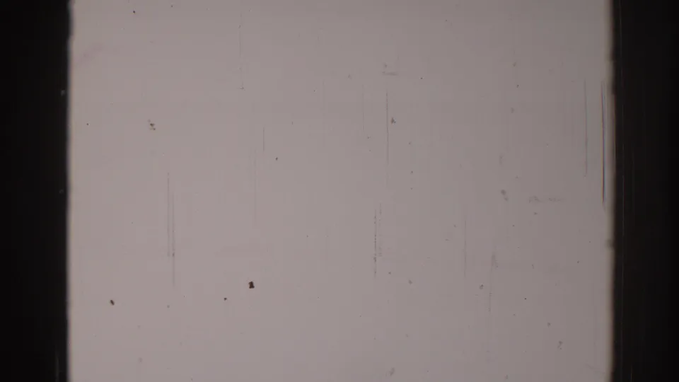 Late frame in the 1967 Los Angeles 8mm clip with a barely discernible carriage-like outline amid heavy fading.