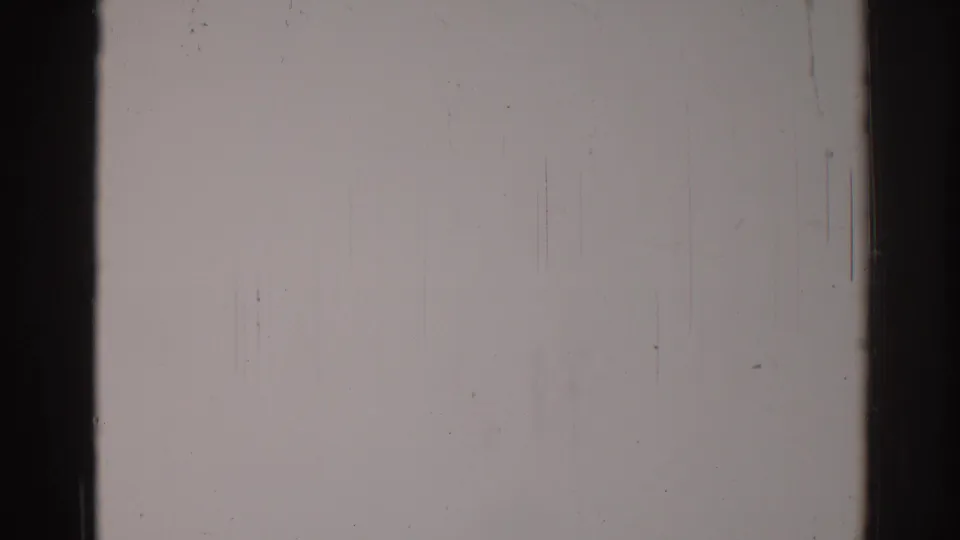 1967 Los Angeles 8mm reel frame showing worn film surface, side border darkness, dust flecks, fine scratches, and scan grain.