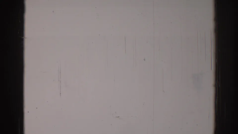 Blank 1967 Los Angeles 8mm home-movie frame showing pale film, dark frame edges, vertical scratches, dust, and grain.