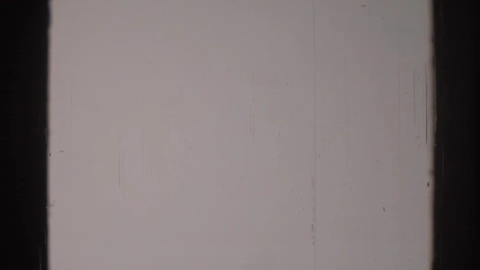 1967 Los Angeles 8mm home-movie frame showing blank exposed film with dark vertical edges, scratches, dust, and visible grain.