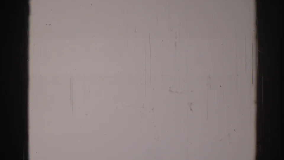 Blank 1967 Los Angeles 8mm home-movie frame with pale exposure, dark edge damage, light vertical scratches, dust specks, and grain.