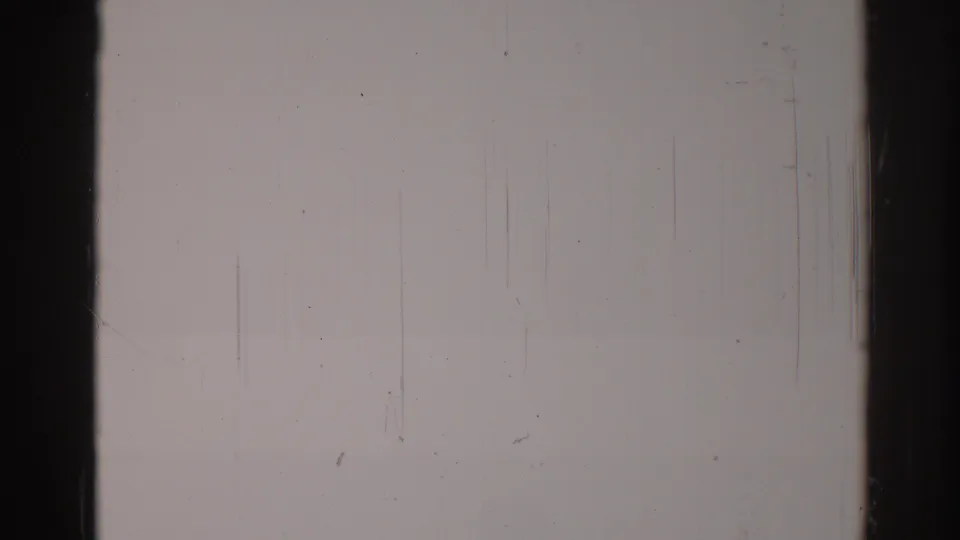Overexposed 1967 8mm frame from Los Angeles metadata, showing pale fog-like exposure, dark borders, dust, and vertical scratches.