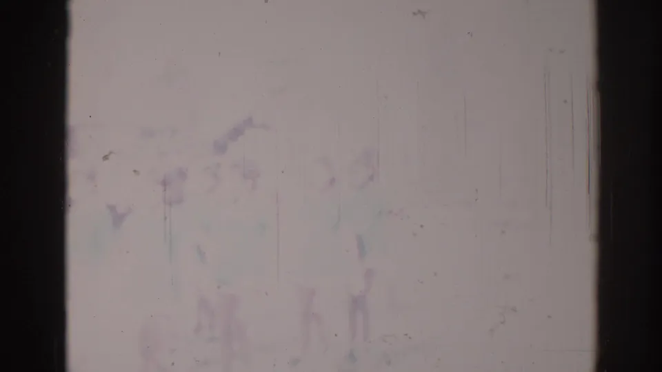Heavily faded 1967 Los Angeles 8mm frame with barely visible parade or festival shapes and prominent film wear.