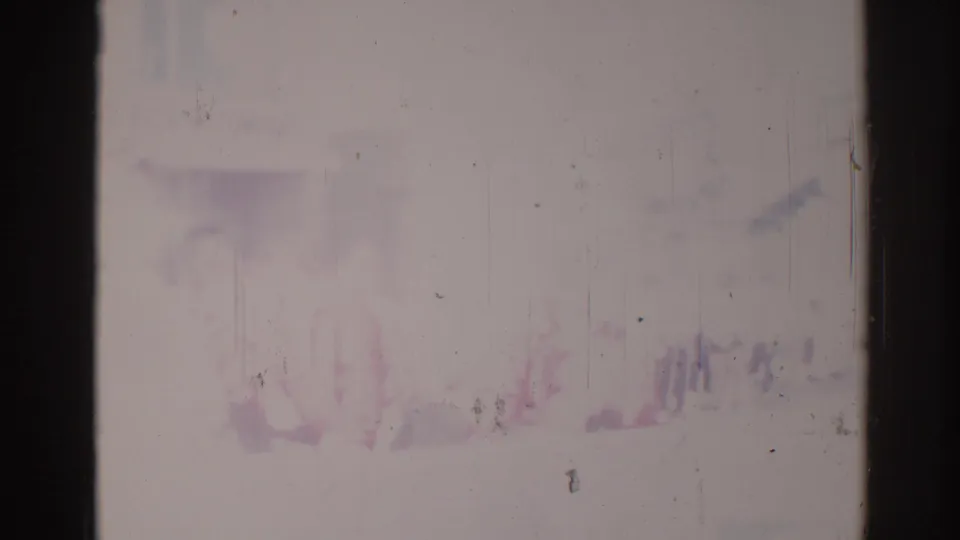 Worn 1967 Los Angeles 8mm frame with faint small shapes near the bottom and severe color fading.