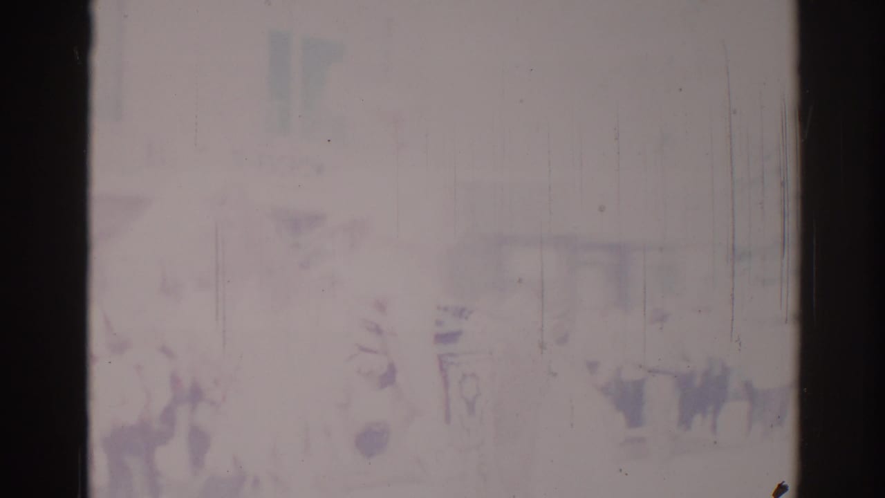 Soft, faded Los Angeles parade frame from 1967 with indistinct spectators or signs visible through scratches and overexposure.