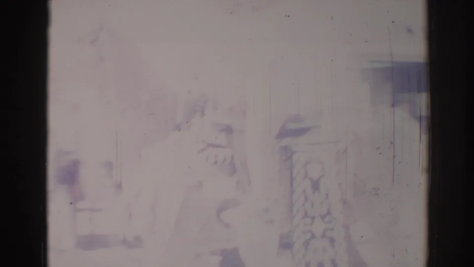 1967 Los Angeles parade footage shows a faint partial figure and decorative parade element, heavily softened by exposure and film aging.