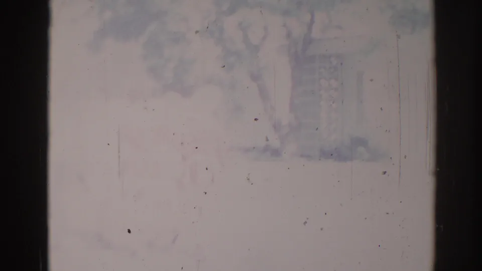 Faded 1967 Los Angeles civic parade frame with an indistinct horse-and-rider form and nearby street details visible through film wear.
