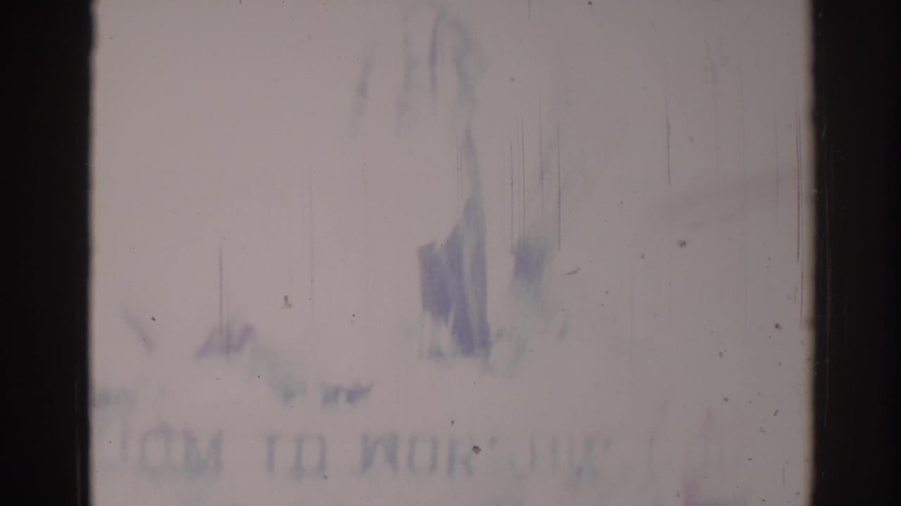Blurred parade signage and decorations with a faint worship-related message.