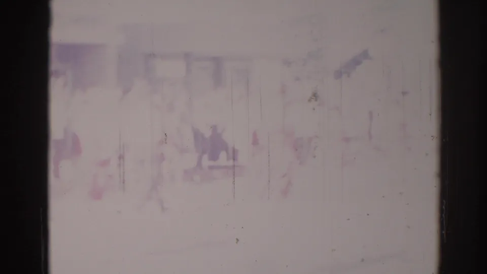 Soft, faded 1967 Los Angeles frame with indistinct people near a building frontage and possible sign elements at the edge.