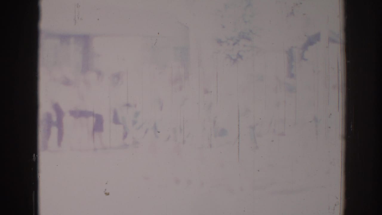 Faded frame with indistinct people in light clothing moving across an urban background.