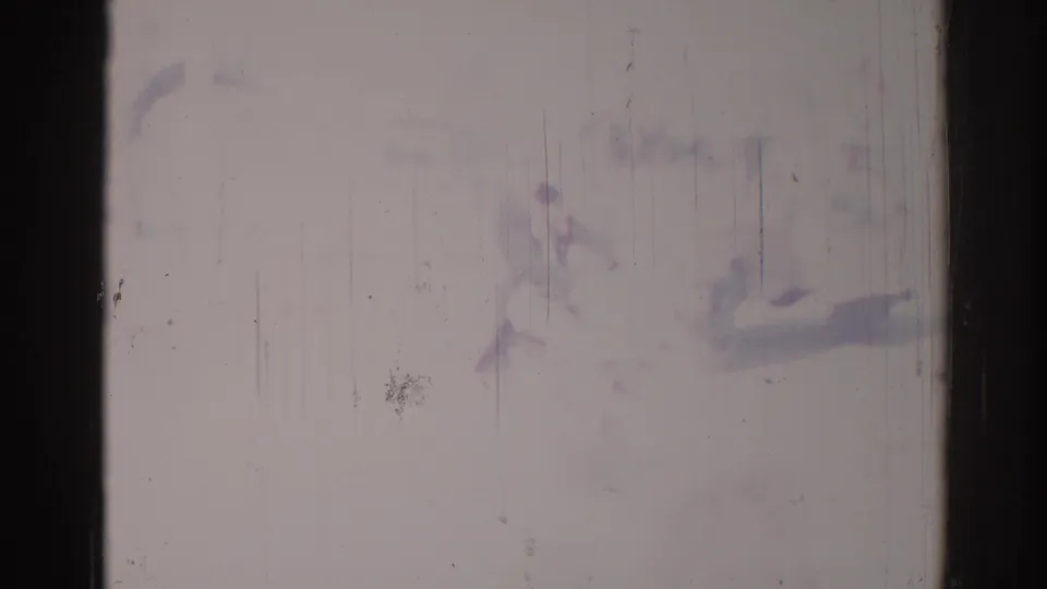 1967 Los Angeles street frame with pale exposure, faint figures, and urban forms partly obscured by film wear.