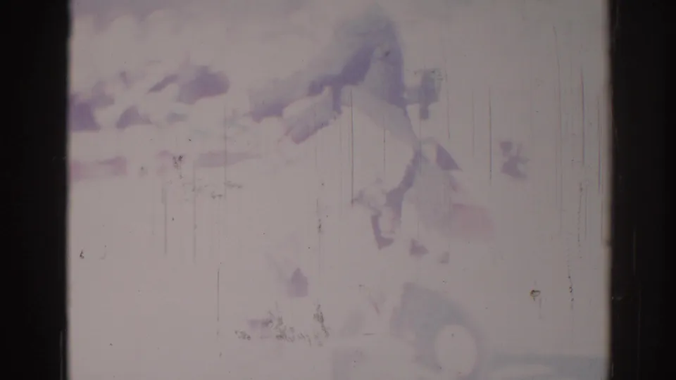 1967 Los Angeles home-movie frame with a soft bicyclist or delivery rider form at right, seen through faded color and scratches.