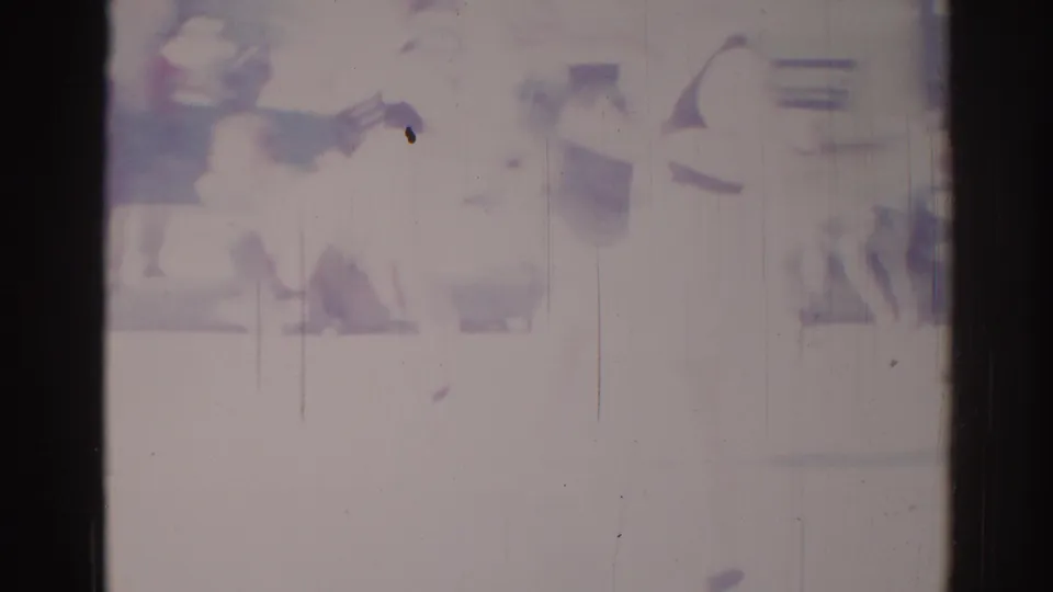 Soft, overexposed 1967 Los Angeles frame with dark performer-like shapes, possible equipment, and visible film wear.