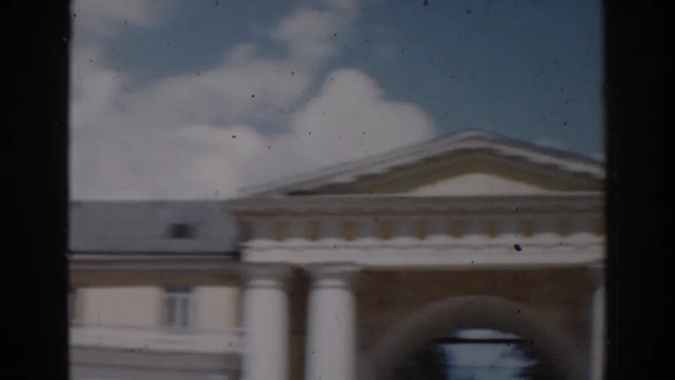1968 Moscow exterior view of a yellow classical-style building with white columns, a pediment, and an arched entrance.