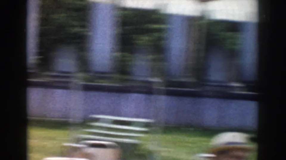 The closing frame shows a blurred outdoor table scene in Moscow, with columns, plants, and adults partly visible at the bottom.