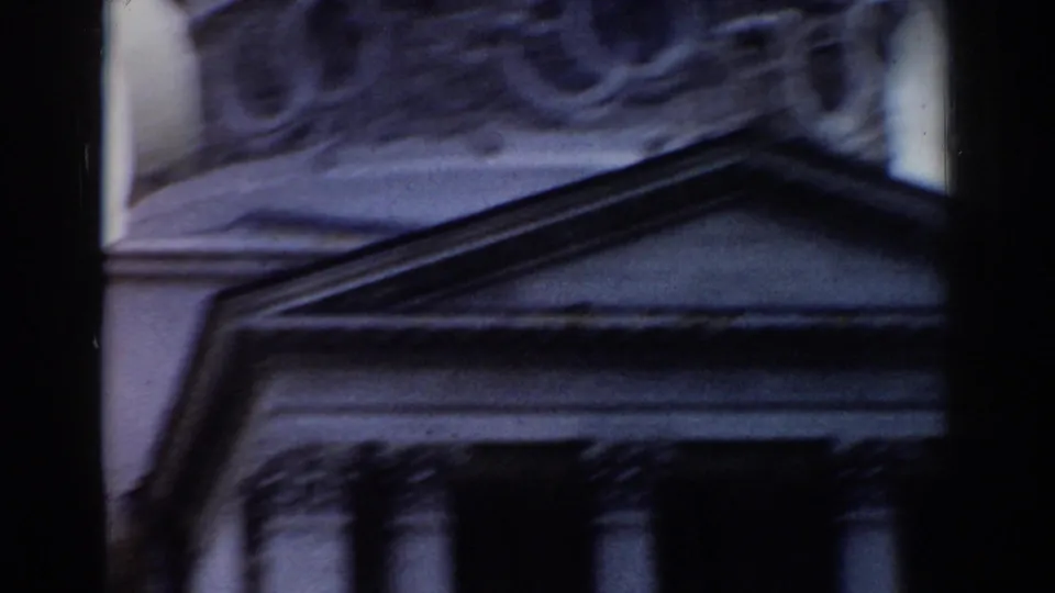 1968 Moscow frame showing a triangular pediment, carved upper facade, and column tops on a classical building exterior.
