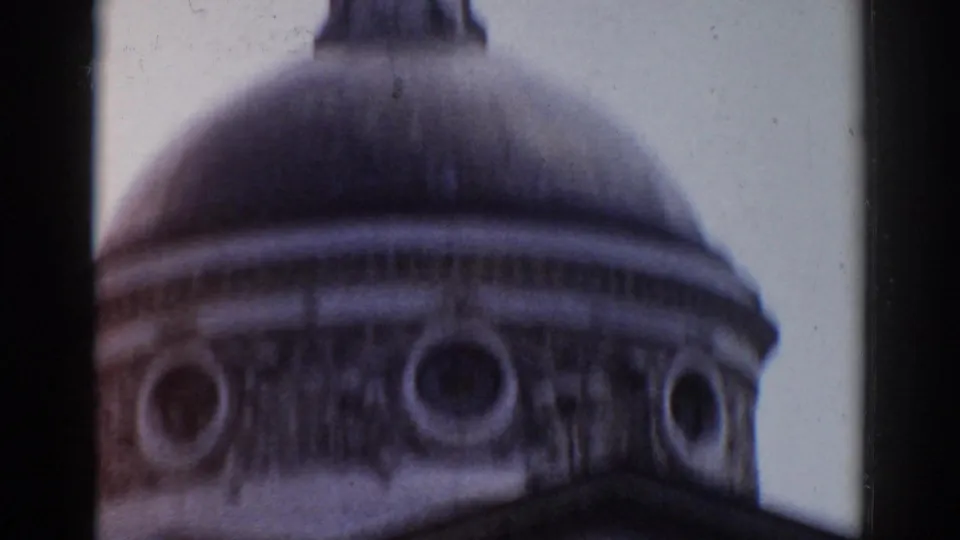 1968 Moscow home-movie frame showing a domed cupola with circular openings and decorative trim, seen from below.