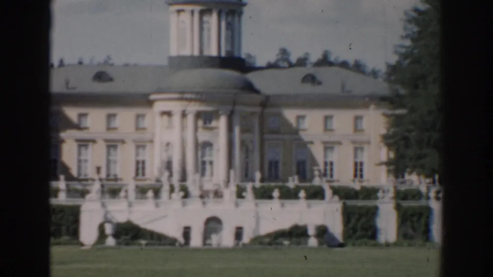 Closer 1968 Moscow 8mm view of the classical facade, central dome, columns, terrace stairs, and green foreground.