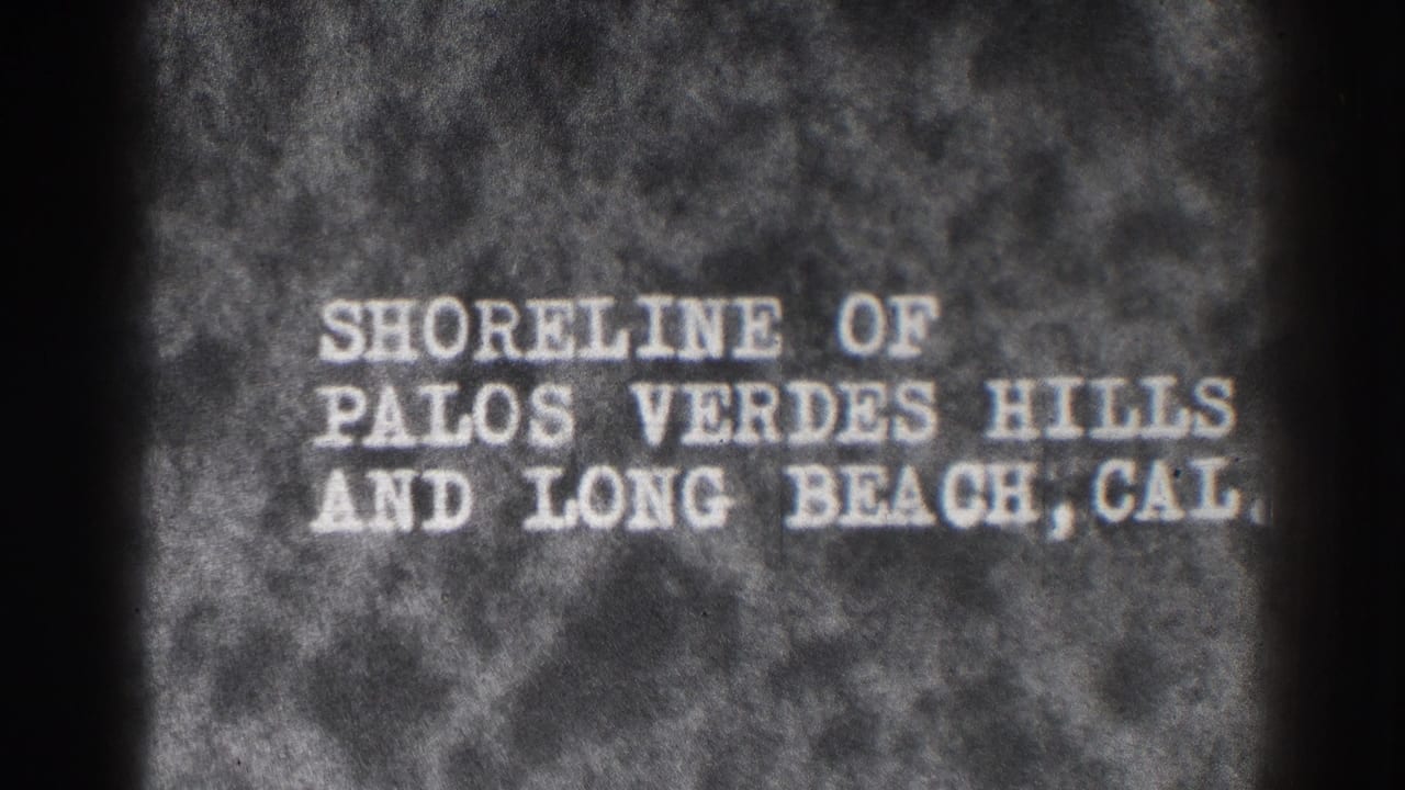 1937 8mm title card reading Shoreline of Palos Verdes Hills and Long Beach, Cal. on a dark textured background.