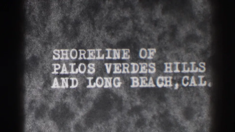 8mm title card for Palos Verdes Hills and Long Beach, California, shown with soft focus and visible grain.