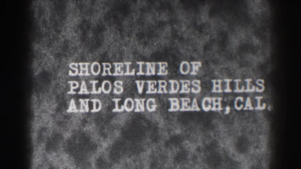 Home-movie title card identifies the shoreline of Palos Verdes Hills and Long Beach, Cal., in a grainy 1930s frame.