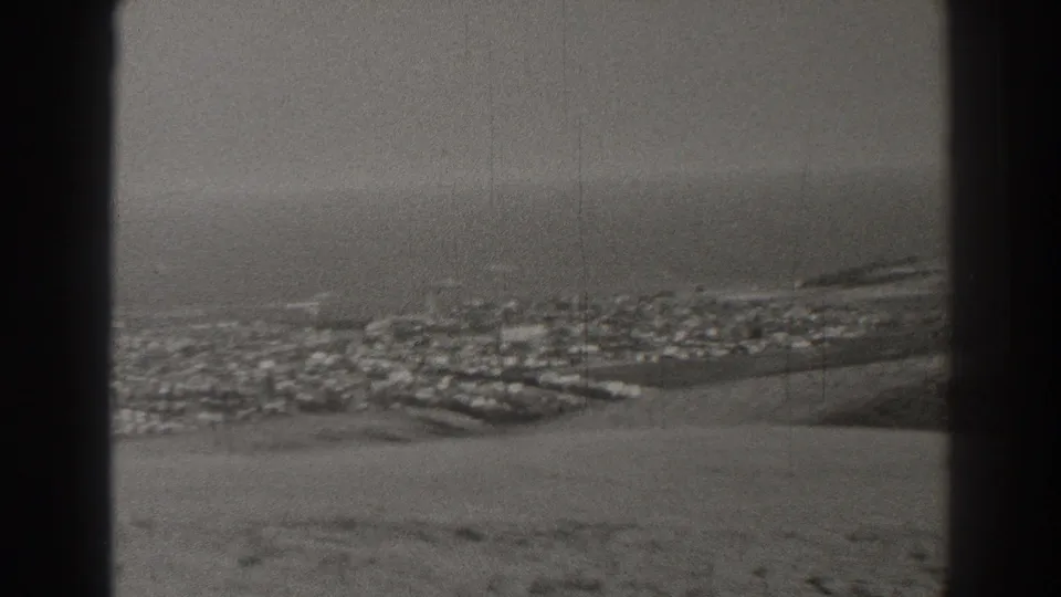 Long Beach city blocks and coastline appear below a hazy Pacific horizon in 1937 home-movie footage.