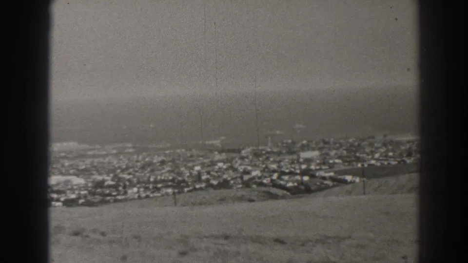 A 1937 high-angle Long Beach view shows low-rise buildings, beach, and Pacific water in soft black-and-white film.