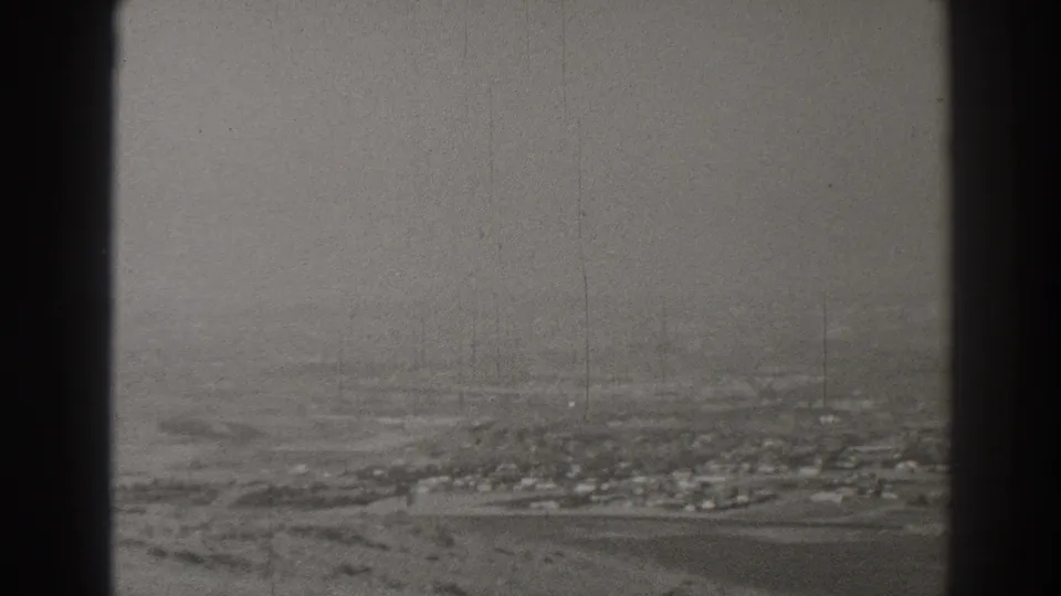 Black-and-white 1937 Long Beach aerial frame showing sparse development, open land, and film wear.
